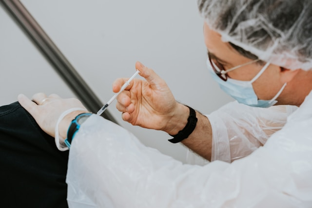 Doctor giving a patient the influenza vaccination