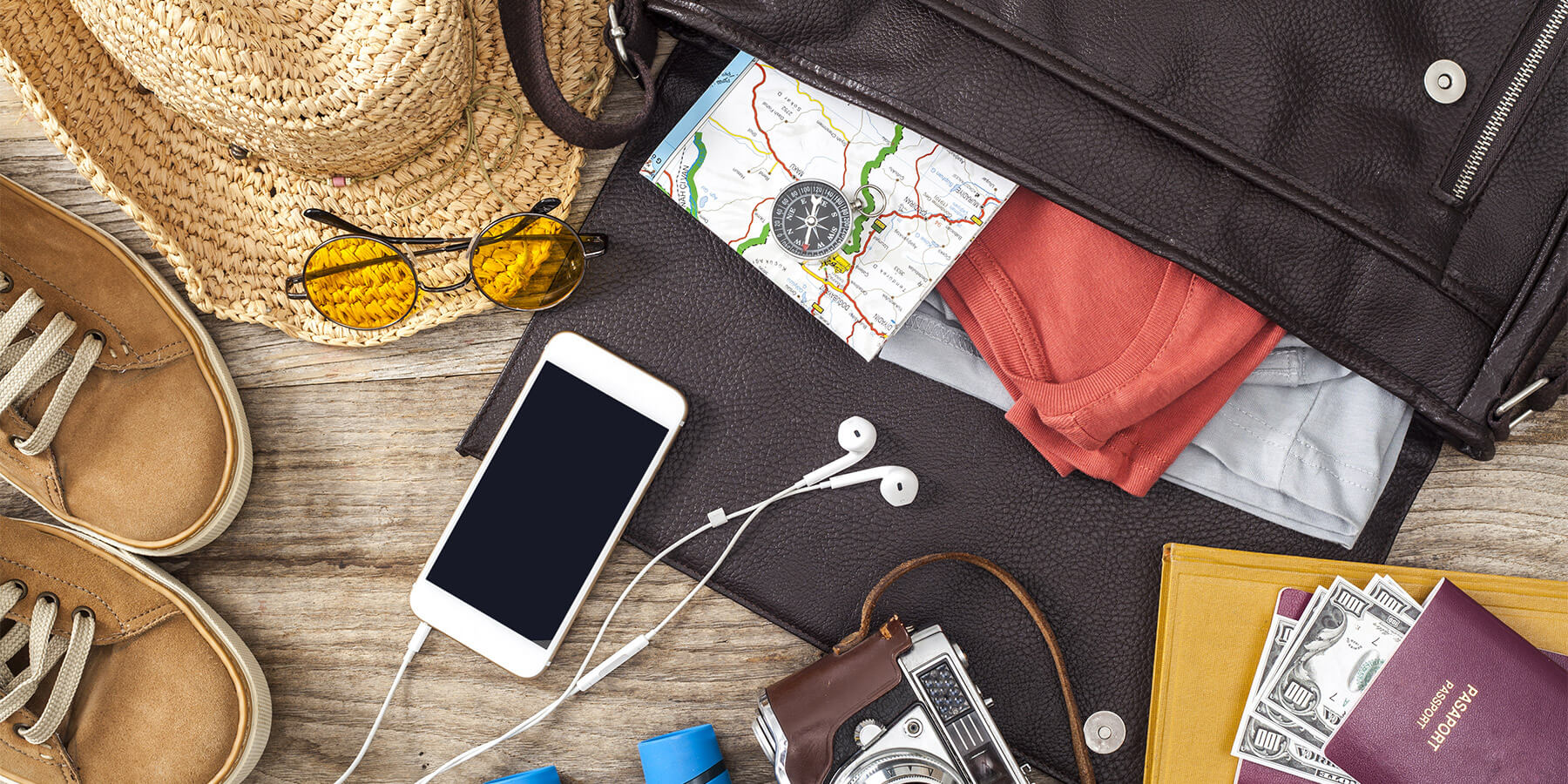 Travel Accessrories Laid out on Wooden Table